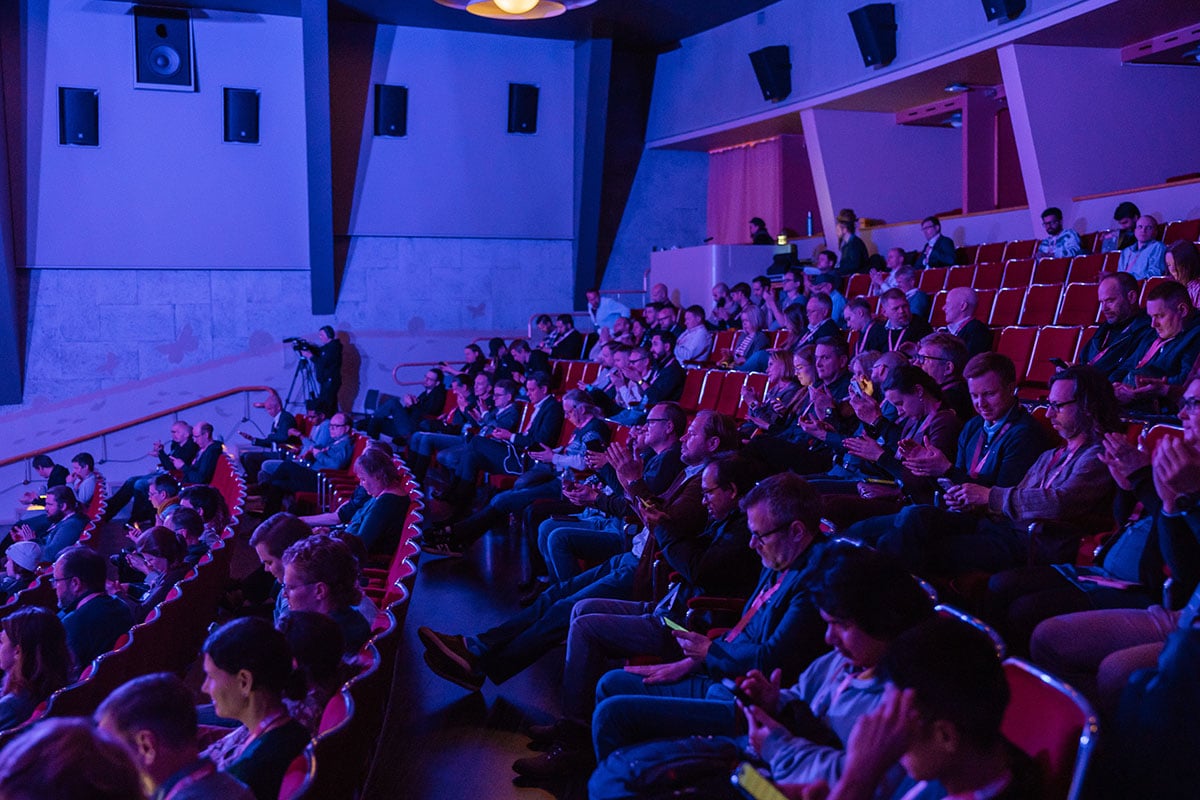 Picture from ADE summit where thousands of people are sitting in audience.