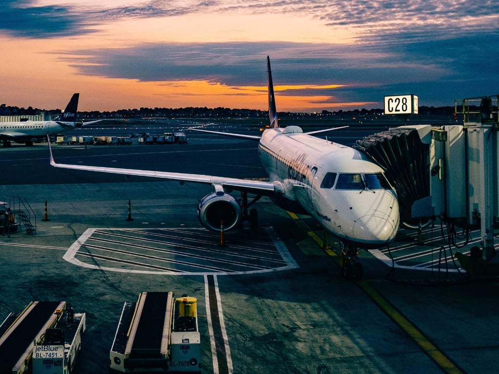 an airplane at the jetway waiting to take passengers to their exciting destinations!
